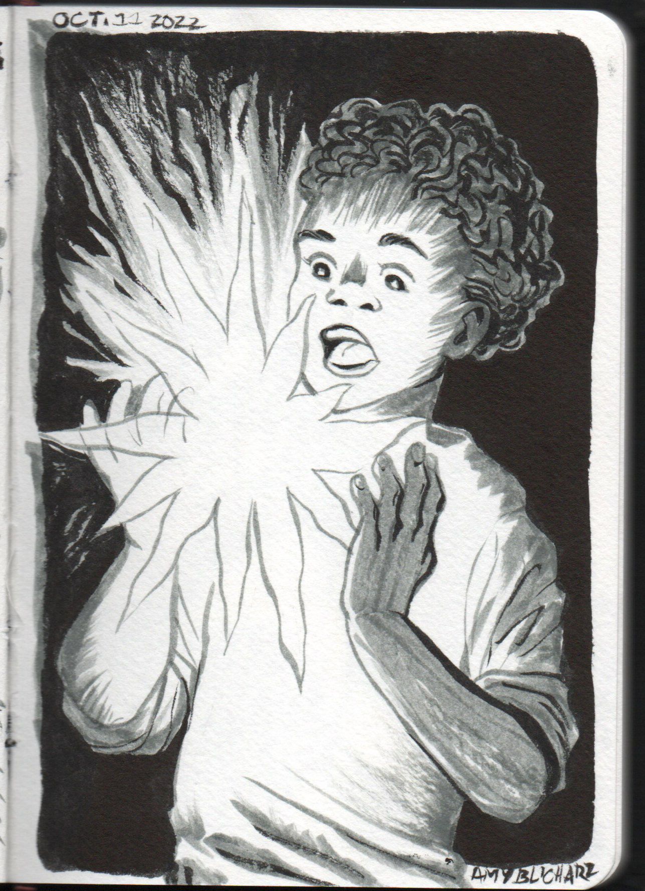 A boy looks in astonishment at a star falling between his hands